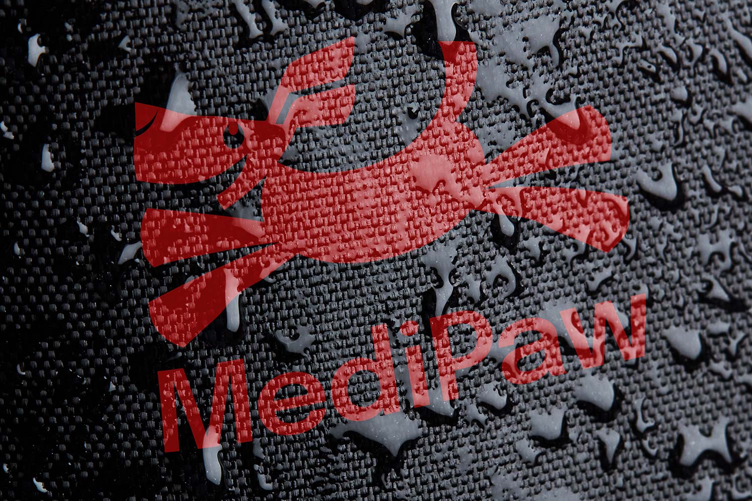 Red 'Medipaw' logo on a textured black background with water droplets to demonstrate water resistance